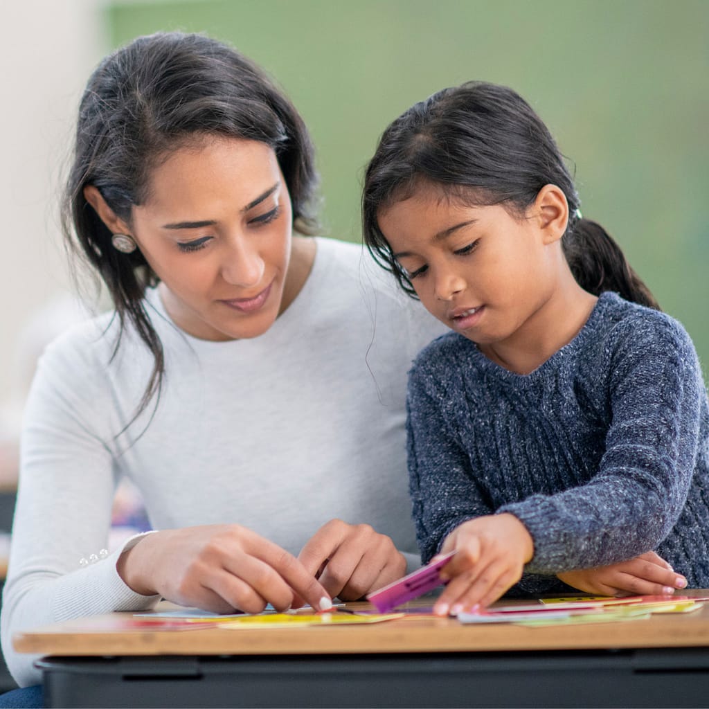 Using Hidden Pictures in Speech Therapy Sessions 4 Image shows a teacher and student working together with a game.